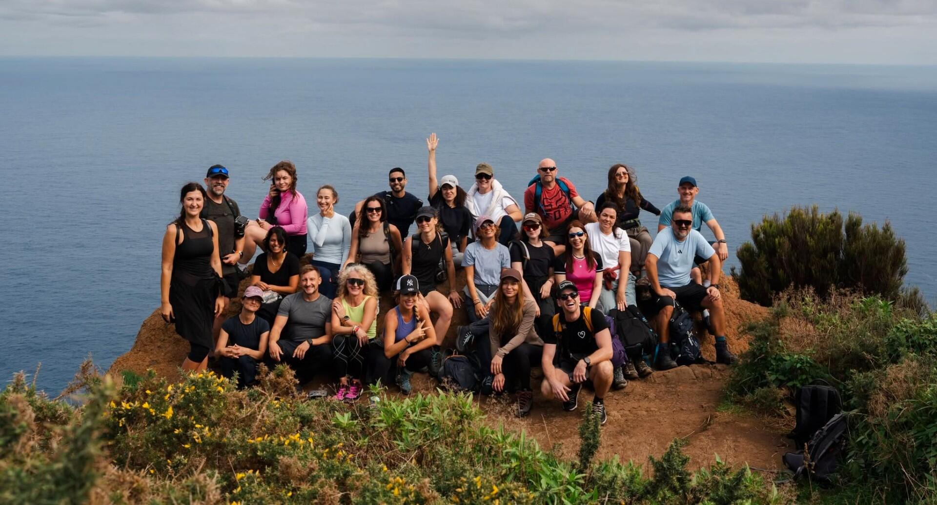 Group of travelers on a Madeira cliff overlooking the ocean